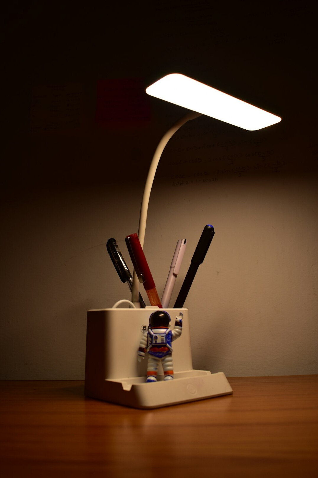 Quiet study desk with a lamp, notebook and fountain pen