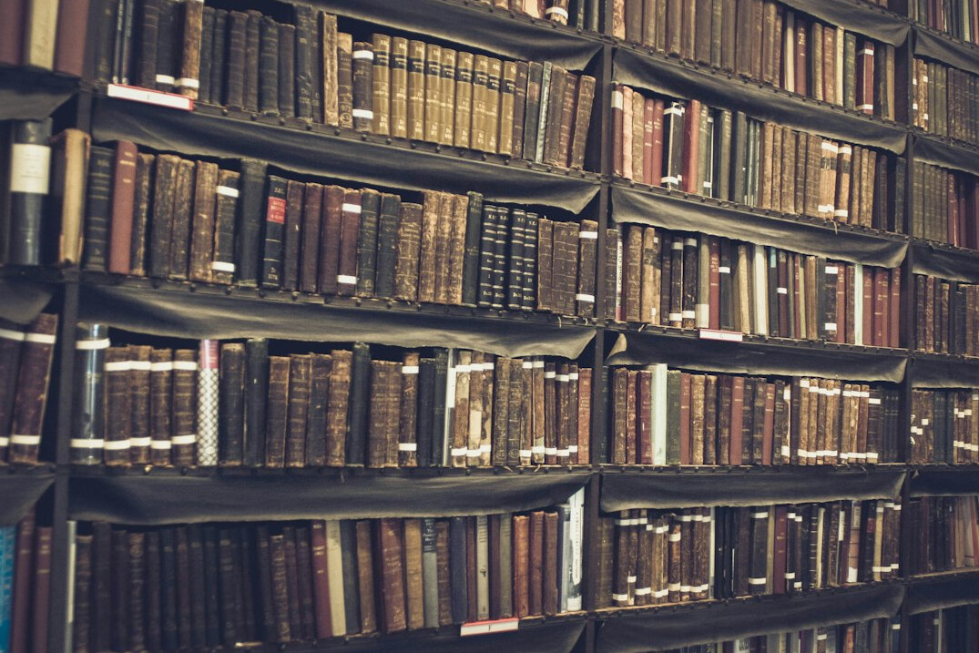 Close-up of dense library bookshelves with aged spines