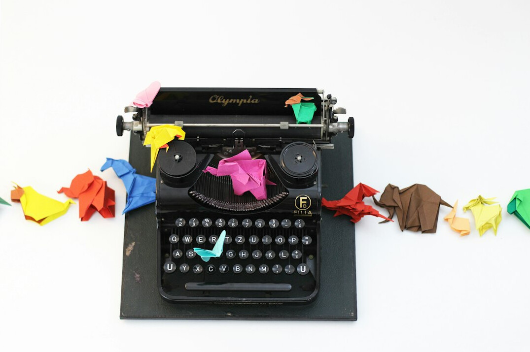 Vintage typewriter with a sheet of paper and scattered notes